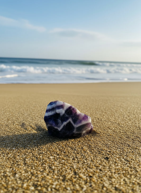 Polished crystal with striped pattern on a white background